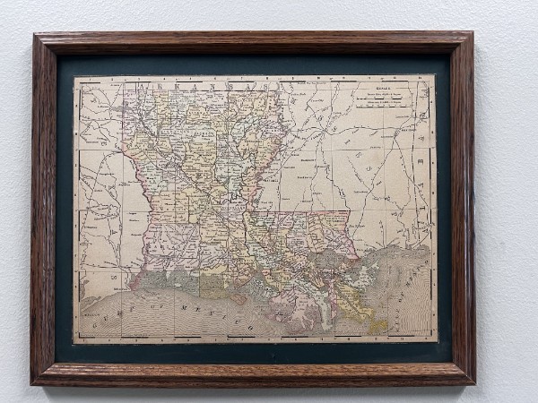 Framed historical map of Louisiana with colored parish boundaries and the Gulf Coast.