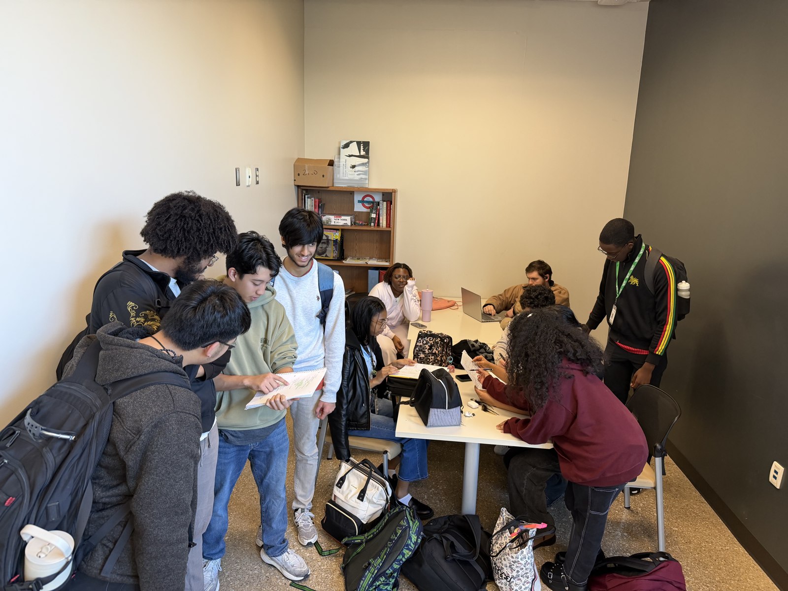 A group gathered around materials in the Center for History and Culture.