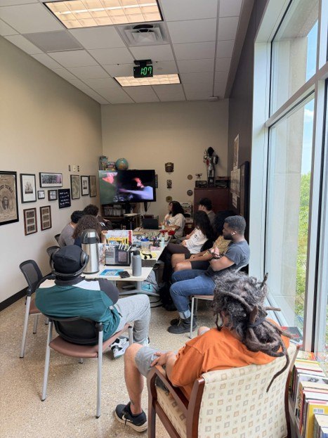 A small group gathered around a table in the Center’s learning space.